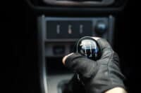 Gear lever. Manual Transmission. Hand on the gear shift in the car.