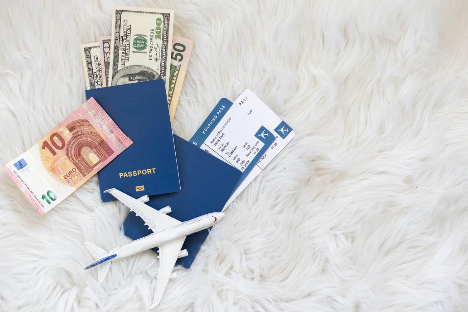 Travel concept, toy plane, passport, money