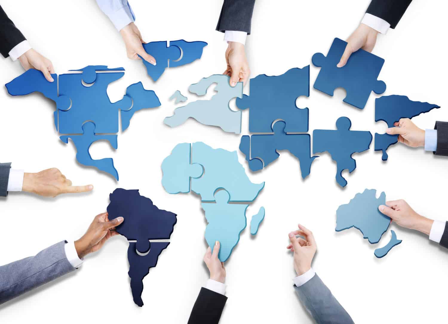 Business People with Jigsaw Puzzle Forming World Map