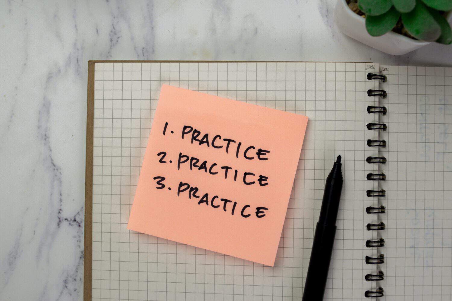 Concept of Practice, Practice, Practice write on sticky notes isolated on Wooden Table.