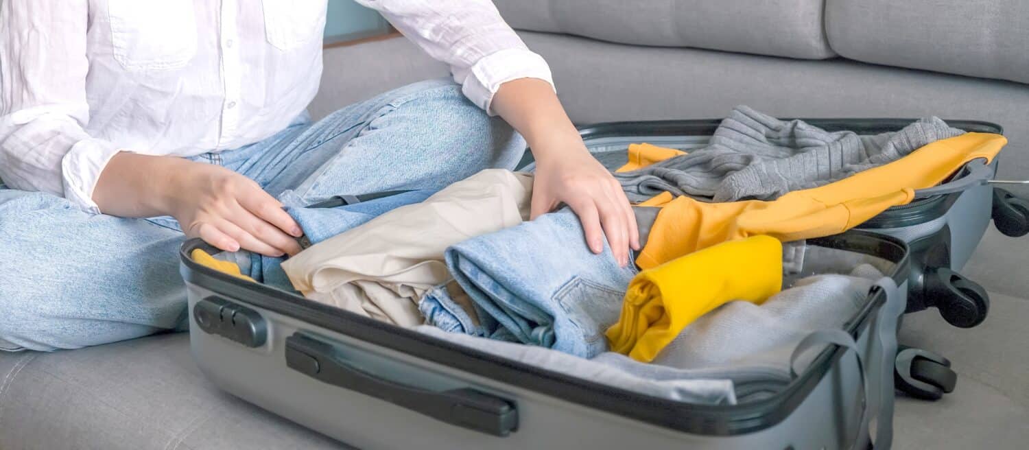 Travel. Staycation.local travel new normal.Girl packing luggage in suitcase and travel documents Travel,tourism,vacation,relocation.Mental health and travel vacation
