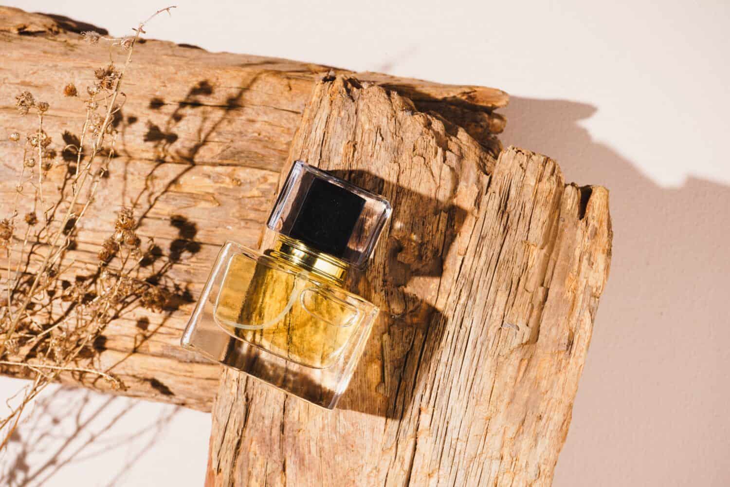 Perfume bottle mockup on old wood, on a beige background