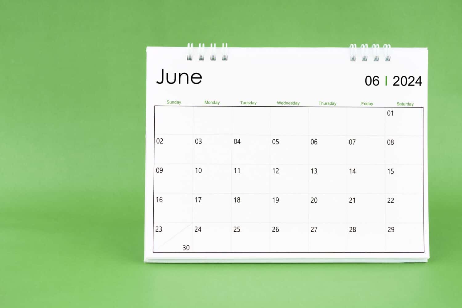 June 2024 desk calendar isolated in green color background.