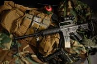 Assault rifle 5.56mm m16 Colt carbine with tactical chest rigs. Military Equipment.