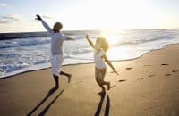Hobe Sound, Florida | Father and daughter (6-7) playing at beach, smiling