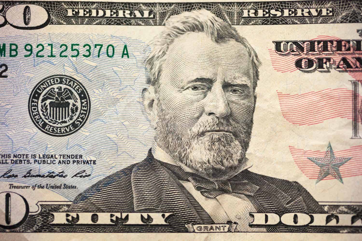 A US $50 bill in the foreground with Ulysses S. Grant. Highly detailed image of US money. Portrait of Ulysses S. Grant on the fifty dollar bill.