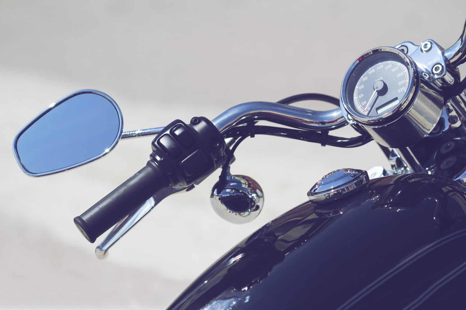 custom black classic motorcycle handlebar and chrome mirror isolated in white background