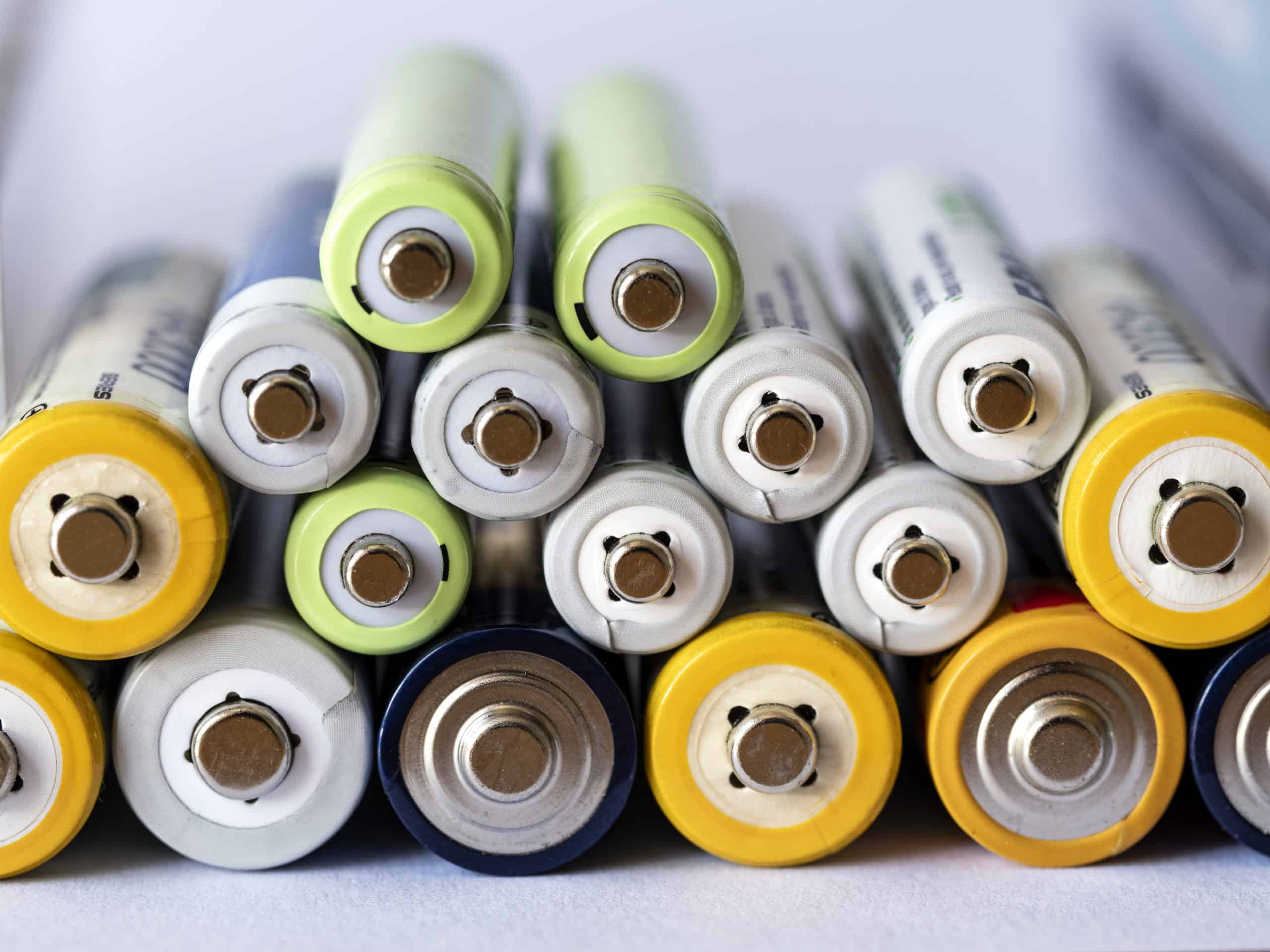 Stack of Ni-MH rechargeable batteries on white background.