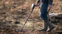 Person using metal detector