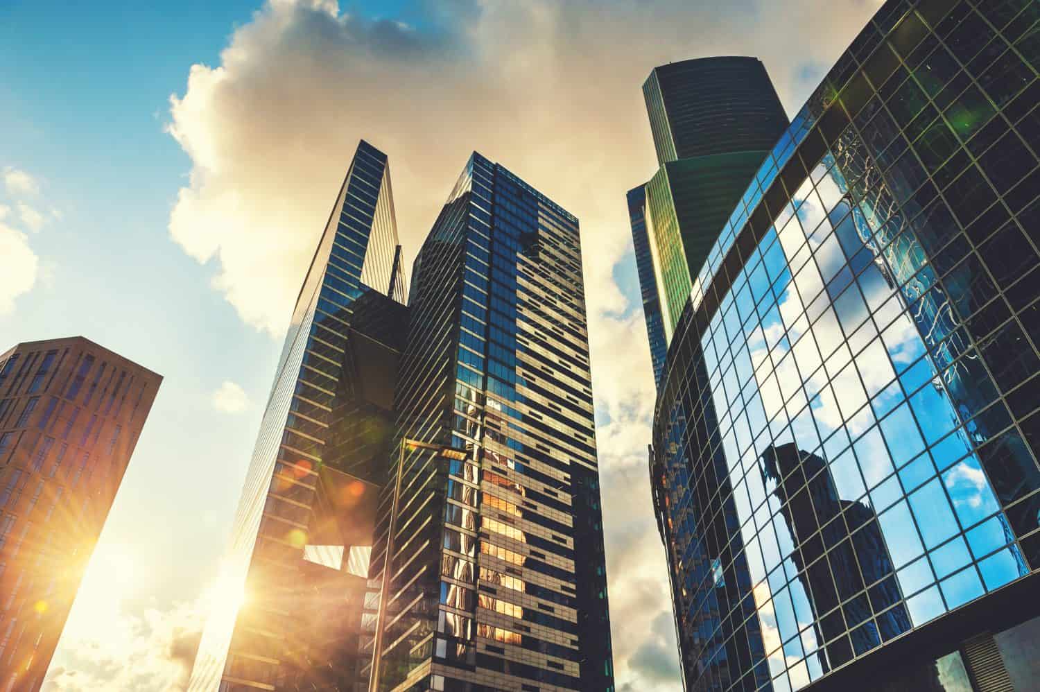 Modern glass skyscrapers in the sunset sky. Bottom up view. Moscow, Russia