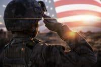 Female Solider Saluting US Flag at Sunrise