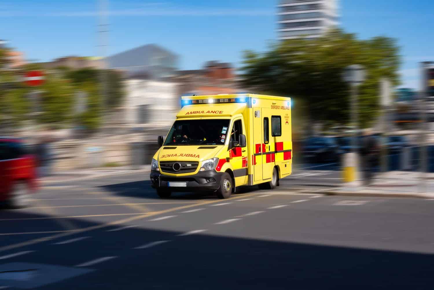 The ambulance that responds to emergency calls drives quickly down the street