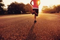Runner athlete running at road. woman fitness sunrise jogging workout wellness concept.