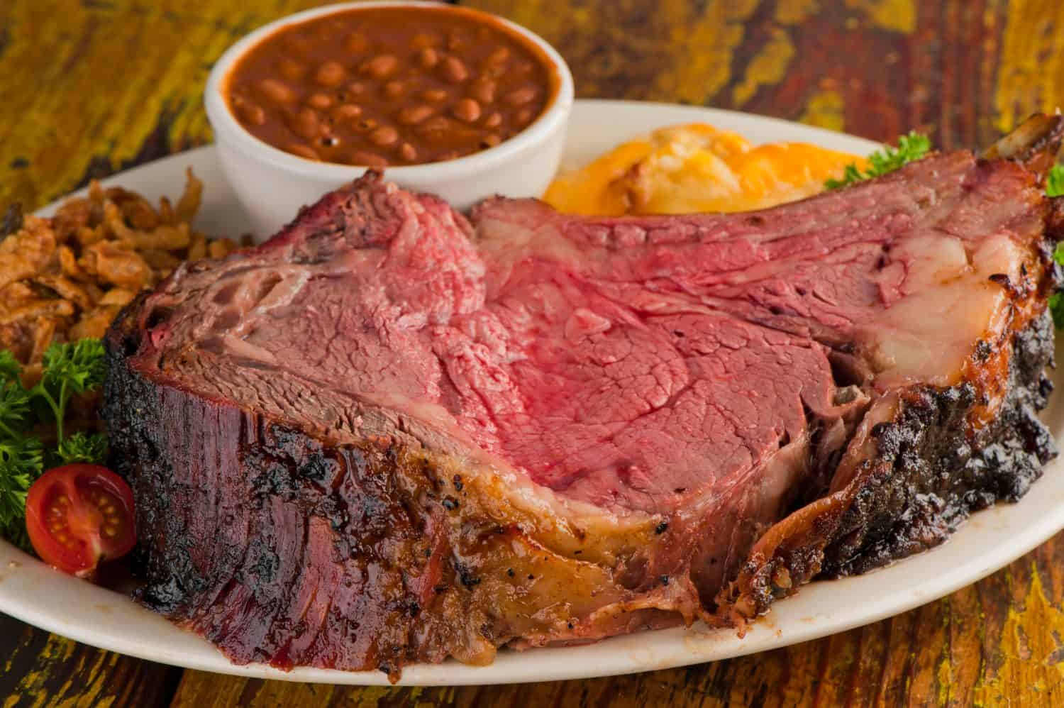 Prime Rib. Prime Rib bbq beef. Beef rubbed with spices and seasonings and slow cooked in a smoker with mesquite wood chips. Traditional Texas Smoke House prime rib beef barbecue.