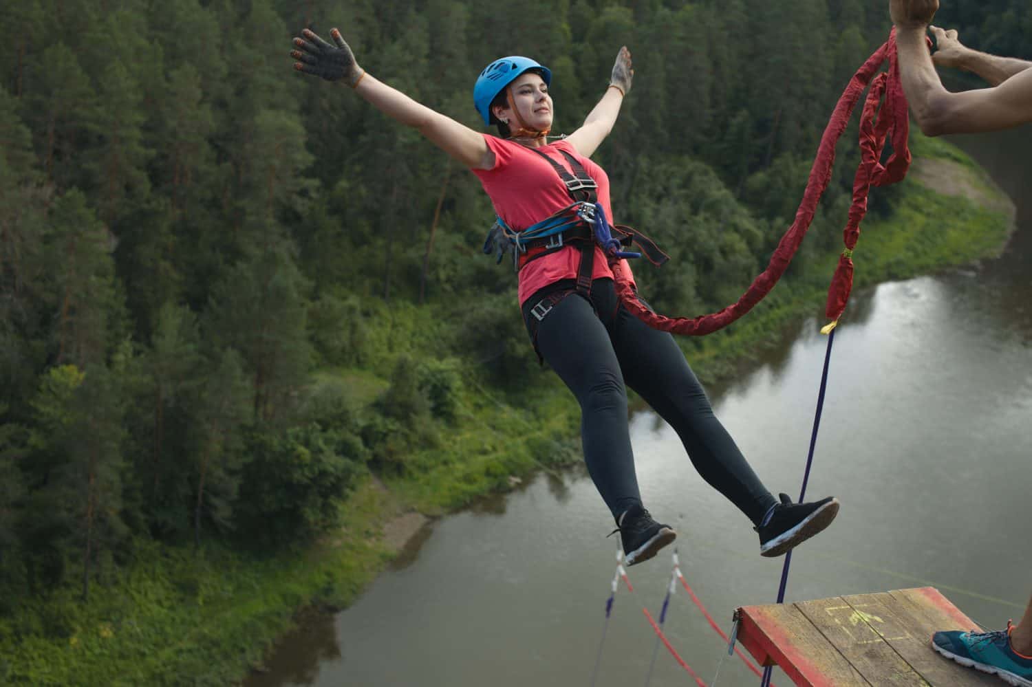 A young woman jumps on a rope from a great height. Jumping rope.