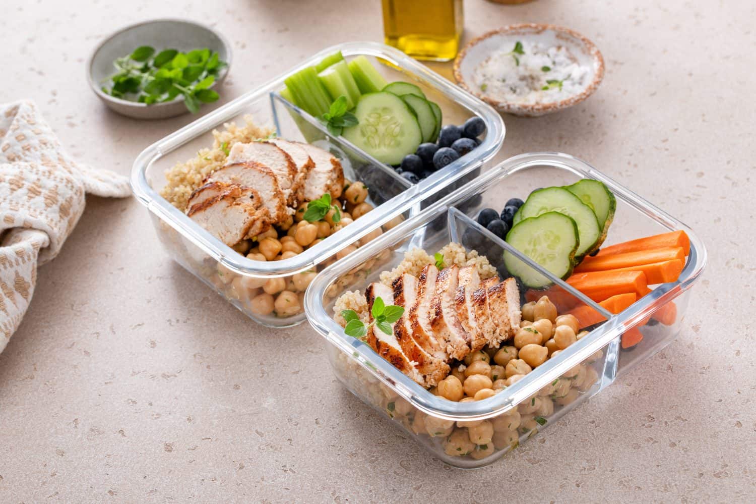 Healthy, protein-rich meal prep containers, cooked quinoa, chickpeas, and eggs