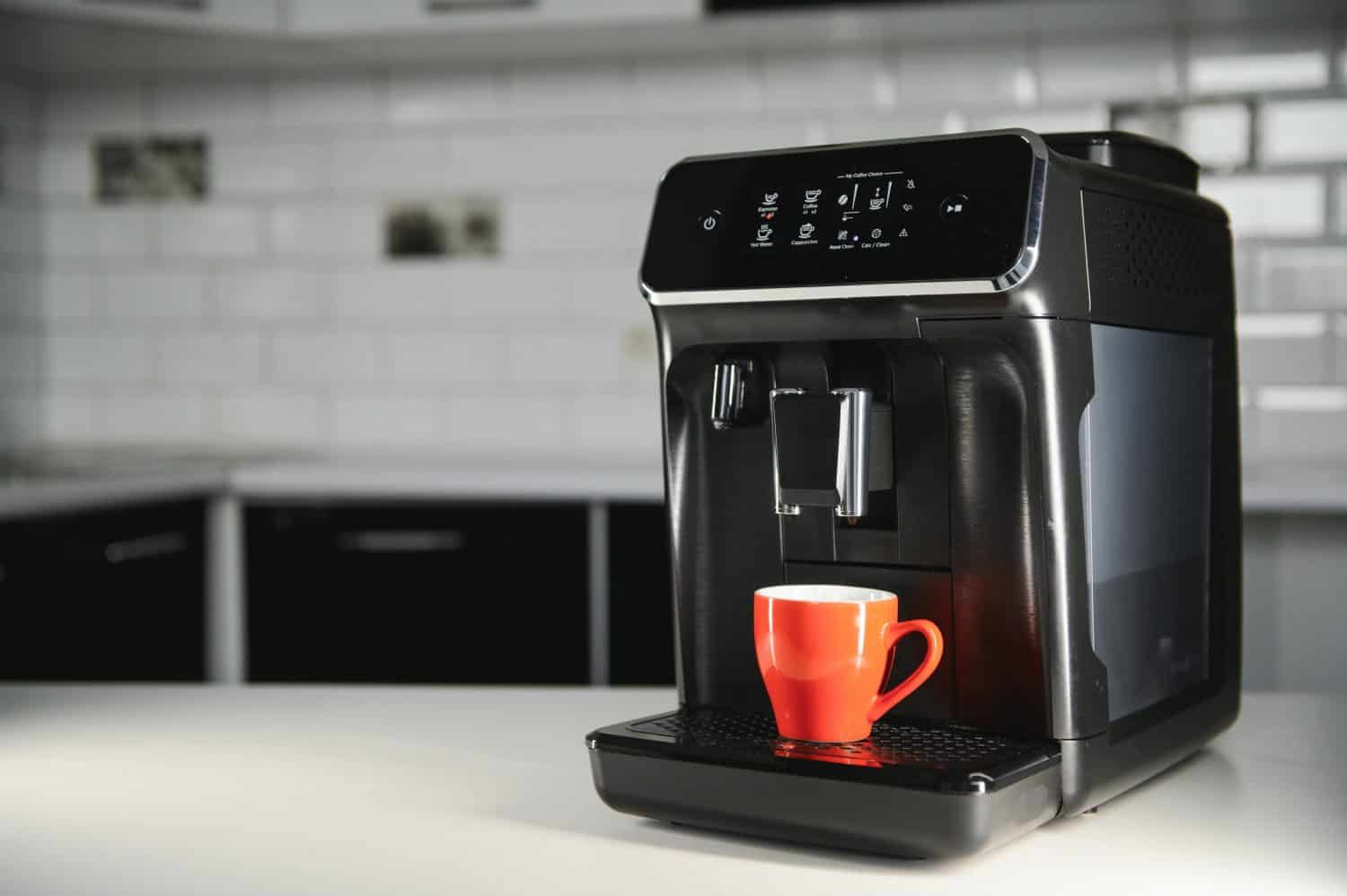 Modern coffee machine on the table in the kitchen.