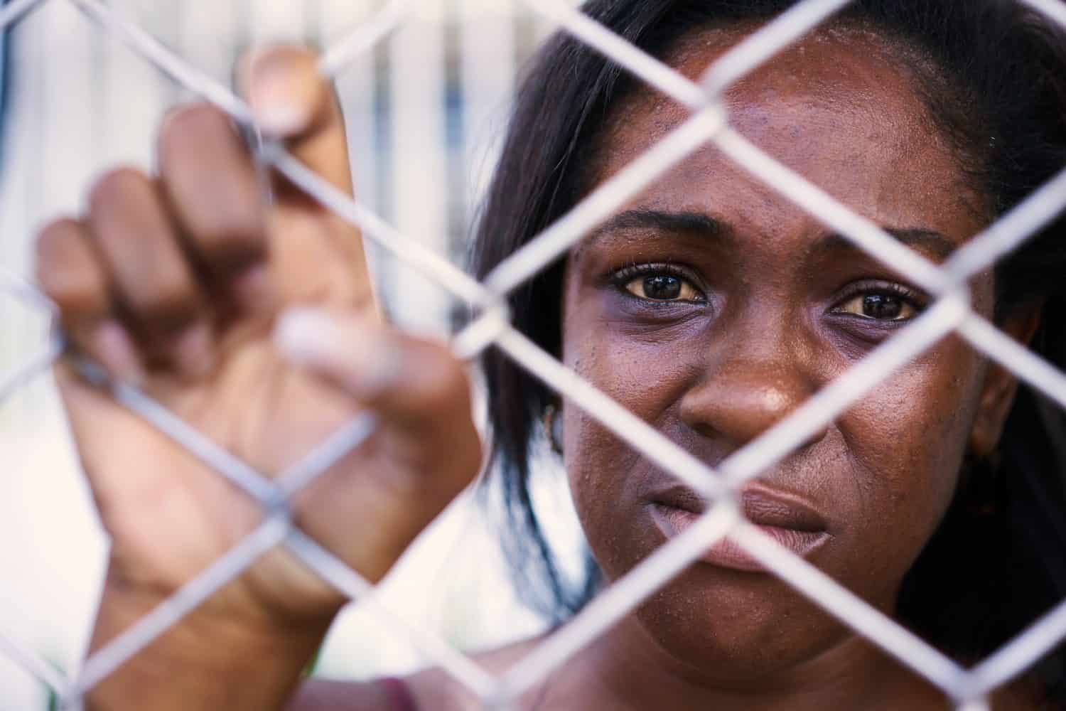 Social issues, abuse and violence against women. Depressed girl, sad African American young woman crying at home. Abused and scared woman