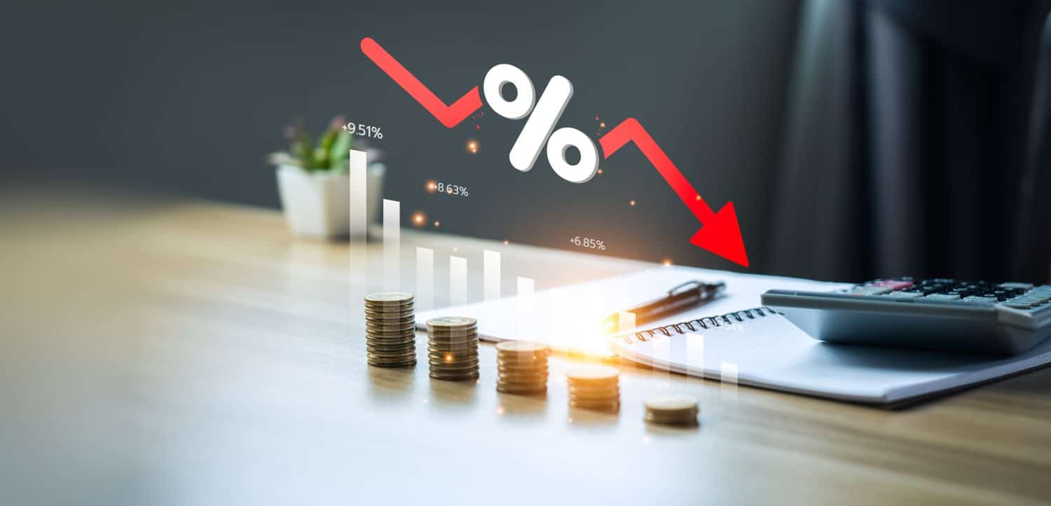 Low risk investment concept, Stacks of coins and an arrow graph pointing down to the lowest point. Reduce financial risk for investments and capital. Risky investment