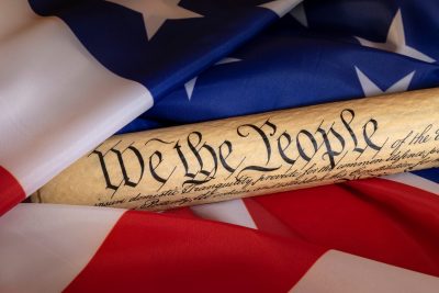 American flag blended with the United States Constitution for use as a symbol of laws, freedom and separation of government powers.