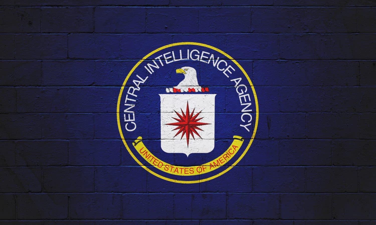 The CIA (Central Intelligence Agency) painted on a brick wall.