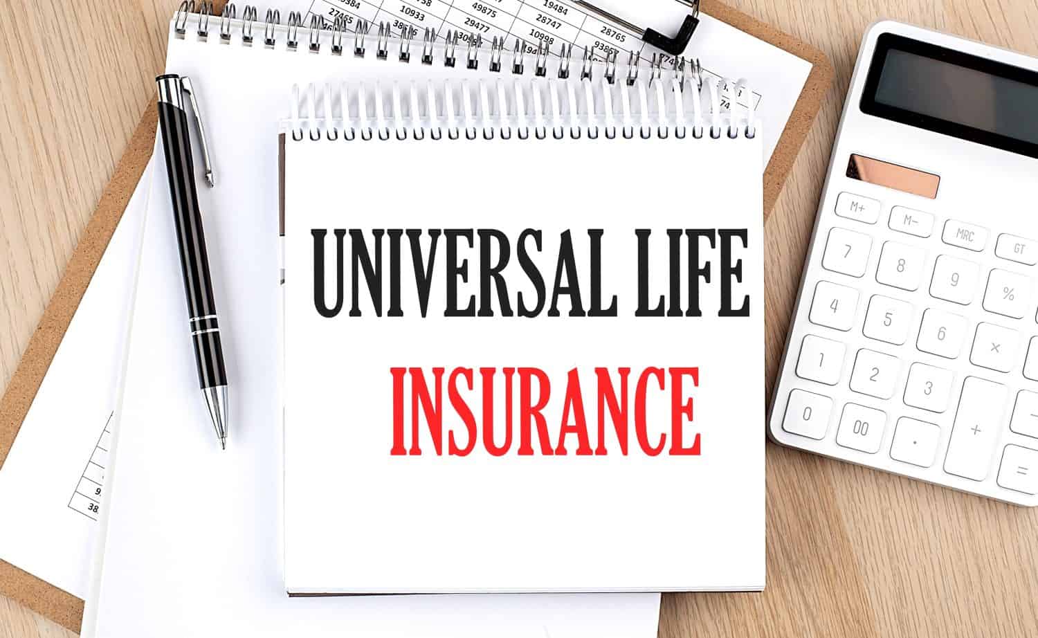 UNIVERSAL LIFE INSURANCE is written in white notepad near calculator, clipboard and pen. Business concept