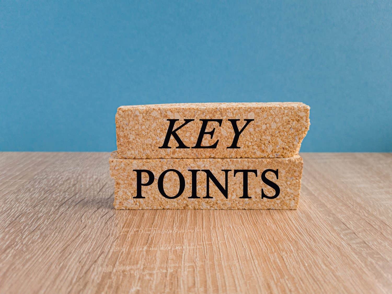 KEY POINTS symbol. Concept words KEY POINTS on brick blocks. Beautiful blue background, wooden table. Business concept. Copy space