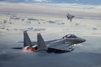 F-15 Eagle Fighter Jets in Flight with afterburner above the fogy mountains