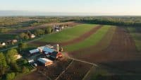 Aerial view of american countryside landscape. Farm, red barn, cows. Rural scenery, farmland. Sunny morning, spring summer season