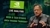 A close-up shot of a middle-aged Asian man wearing glasses and a black leather jacket, gesturing with both hands as if speaking. The background is a dark green grid with overlaid bright green financial bar charts and numbers. Text overlays include 'NVIDIA' logo, '24/7 WALL ST' logo, 'LIVE ANALYSIS:', 'NVDA & TECH STOCKS', and 'OPEN TRADING THURSDAY'.