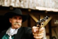 Portrait of Cowboy Holding Gun