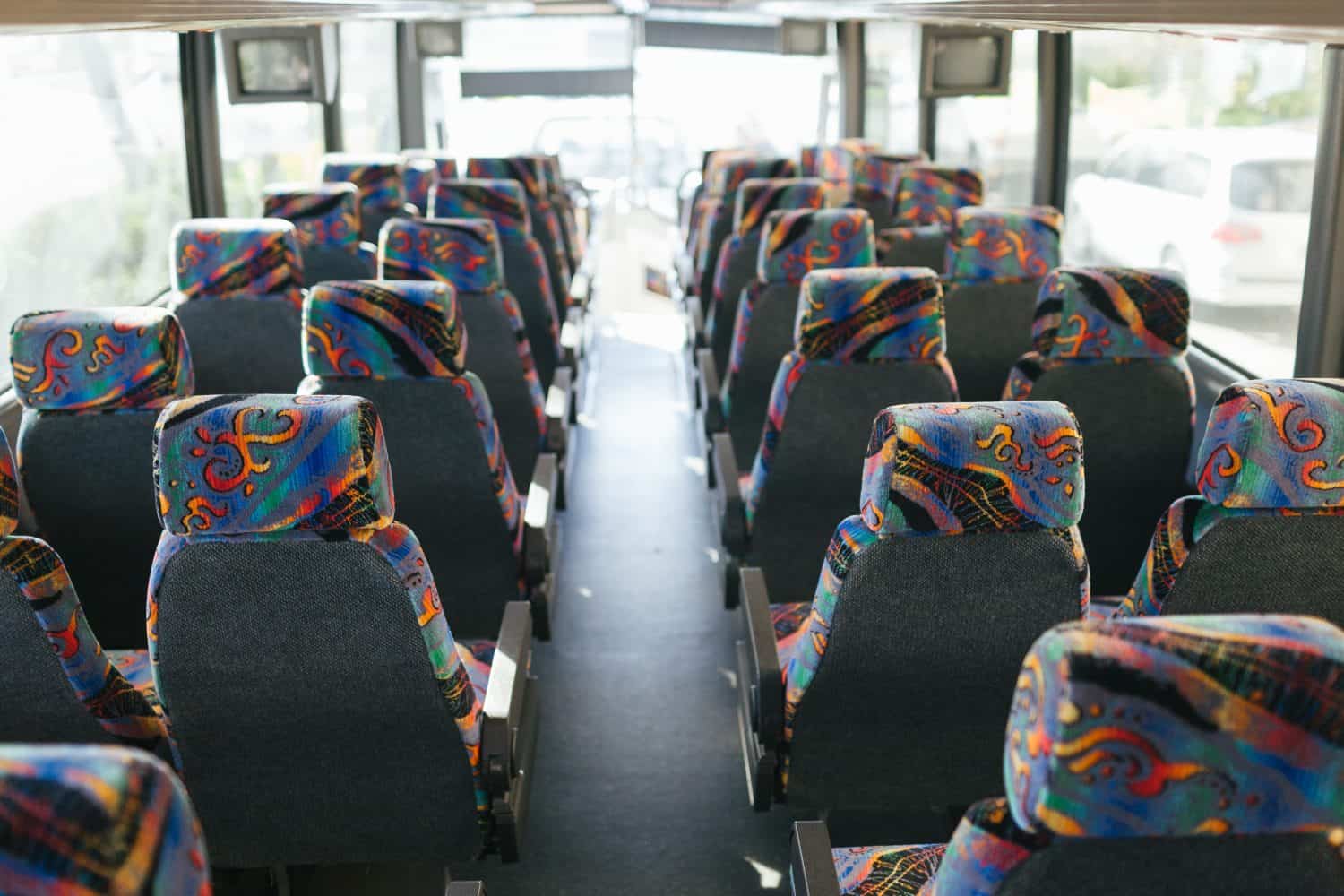 Inside of a big tour bus. Empty seats waiting for passengers.