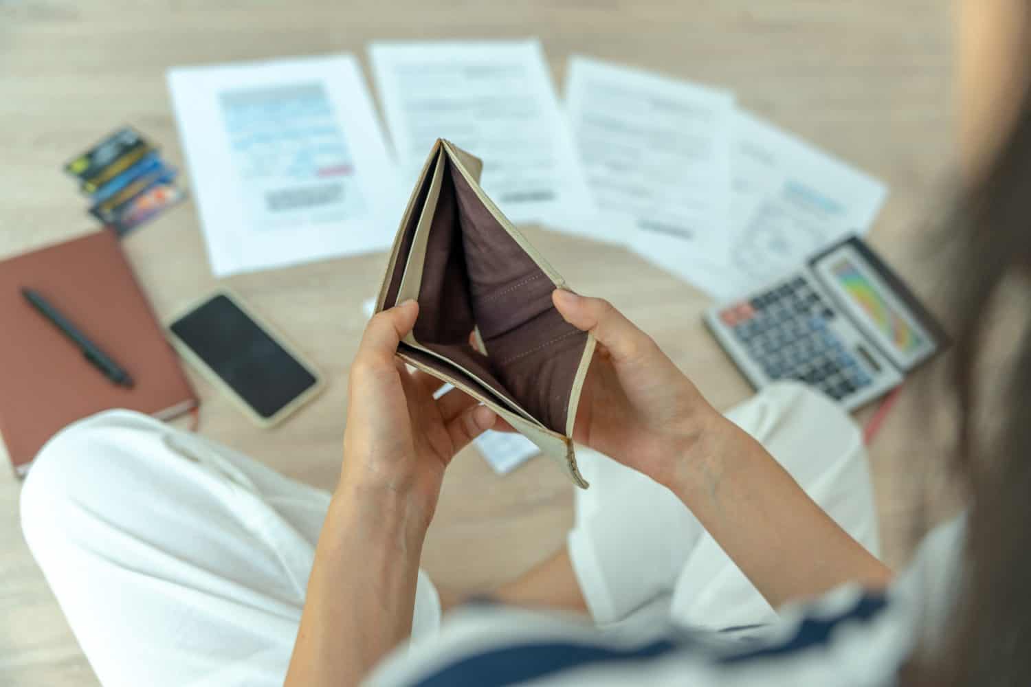 Women managing debt and expenses. People holding wallet but no money to pay credit card. broke, mortgage, loan, bankruptcy, bankrupt, can't to pay