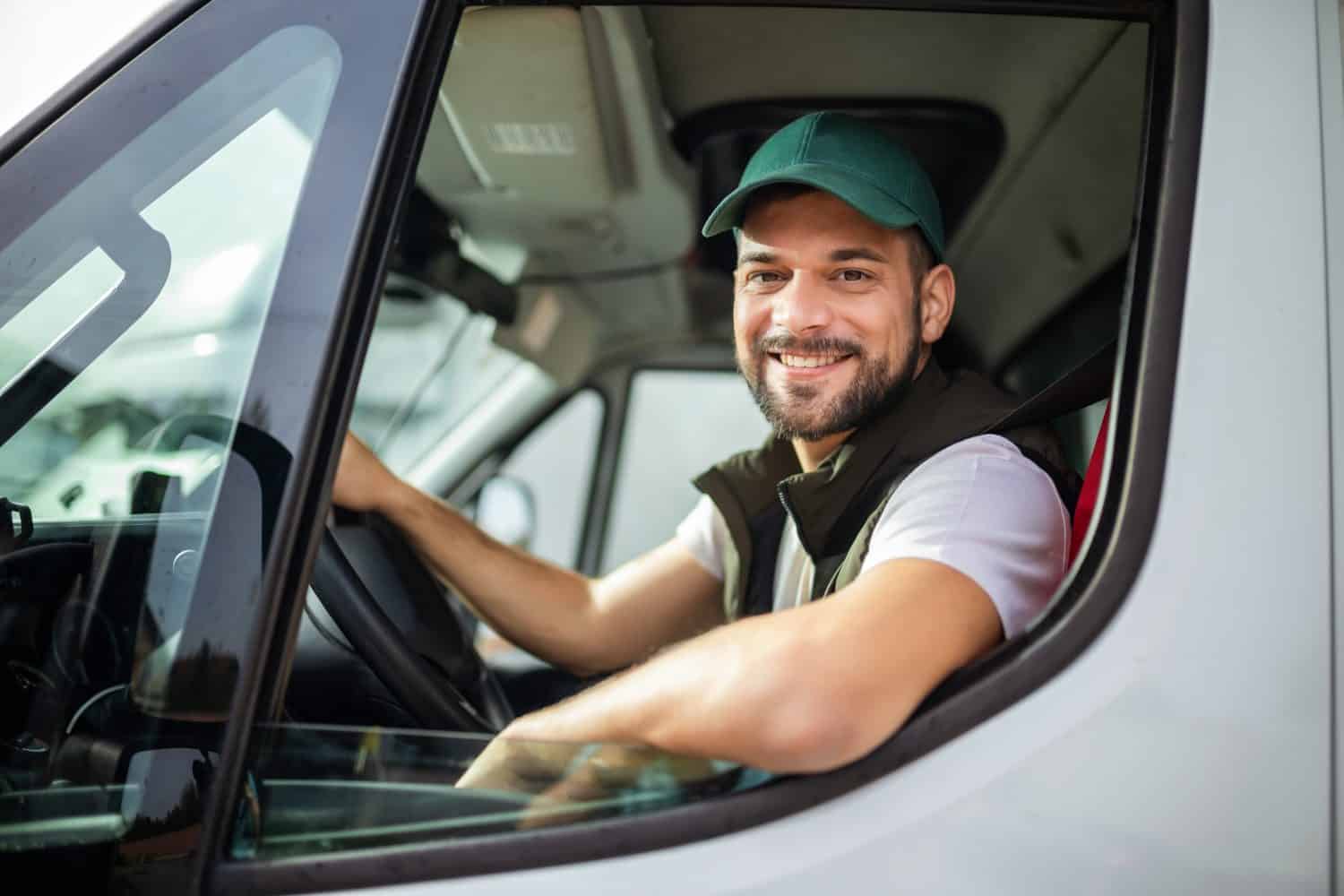 Young handsome man working in towing service and driving his truck.