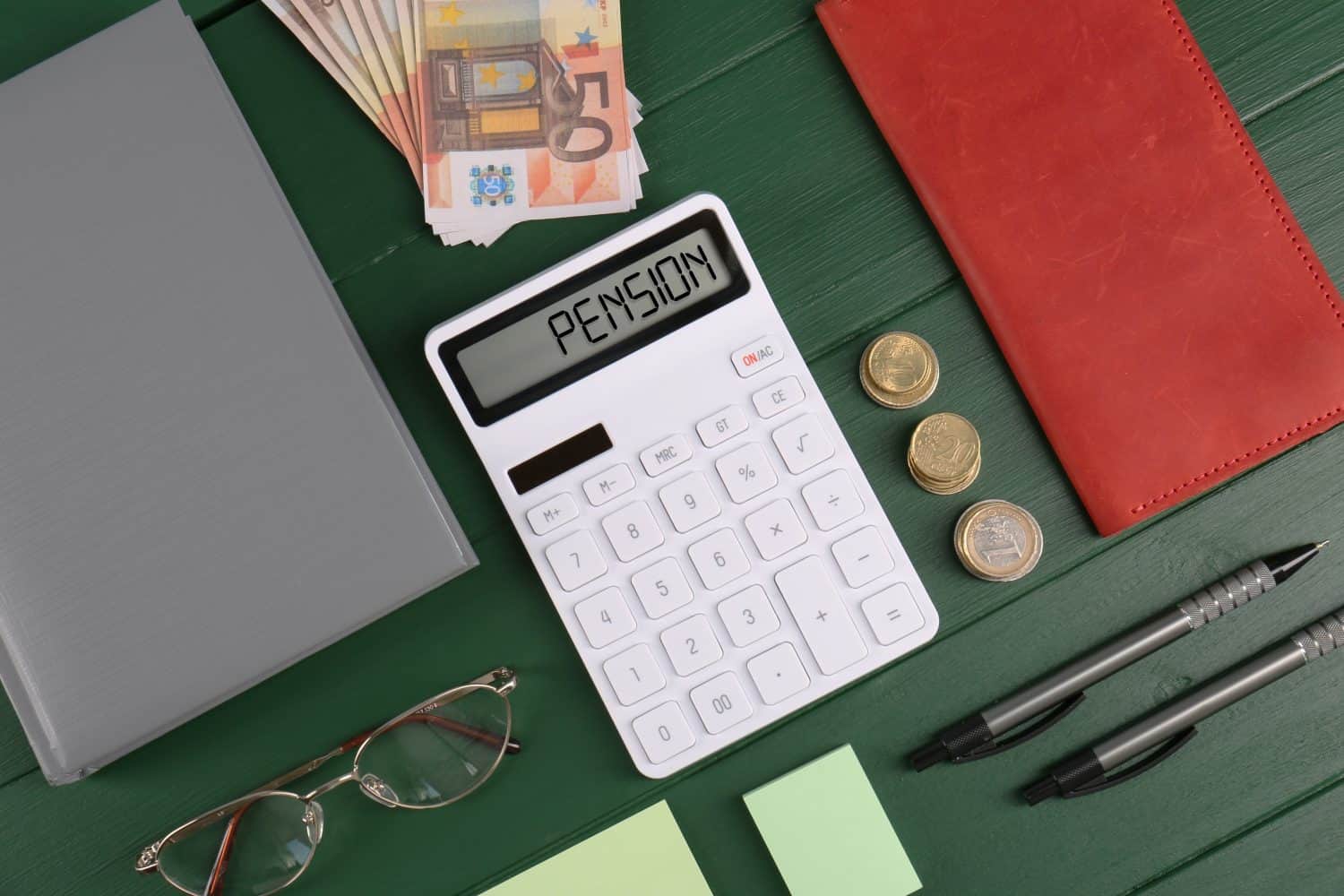 Calculator with word Pension, money, glasses and stationery on green wooden table, flat lay