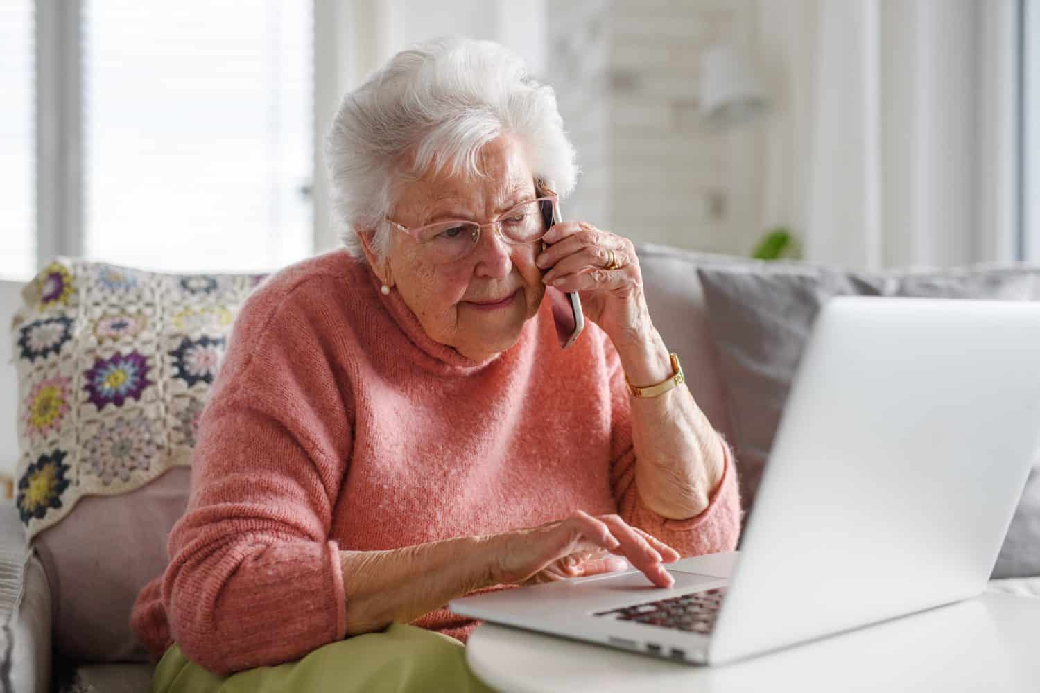 Senior woman working with laptop, shopping online, making call. Importance of digital literacy for elderly people.