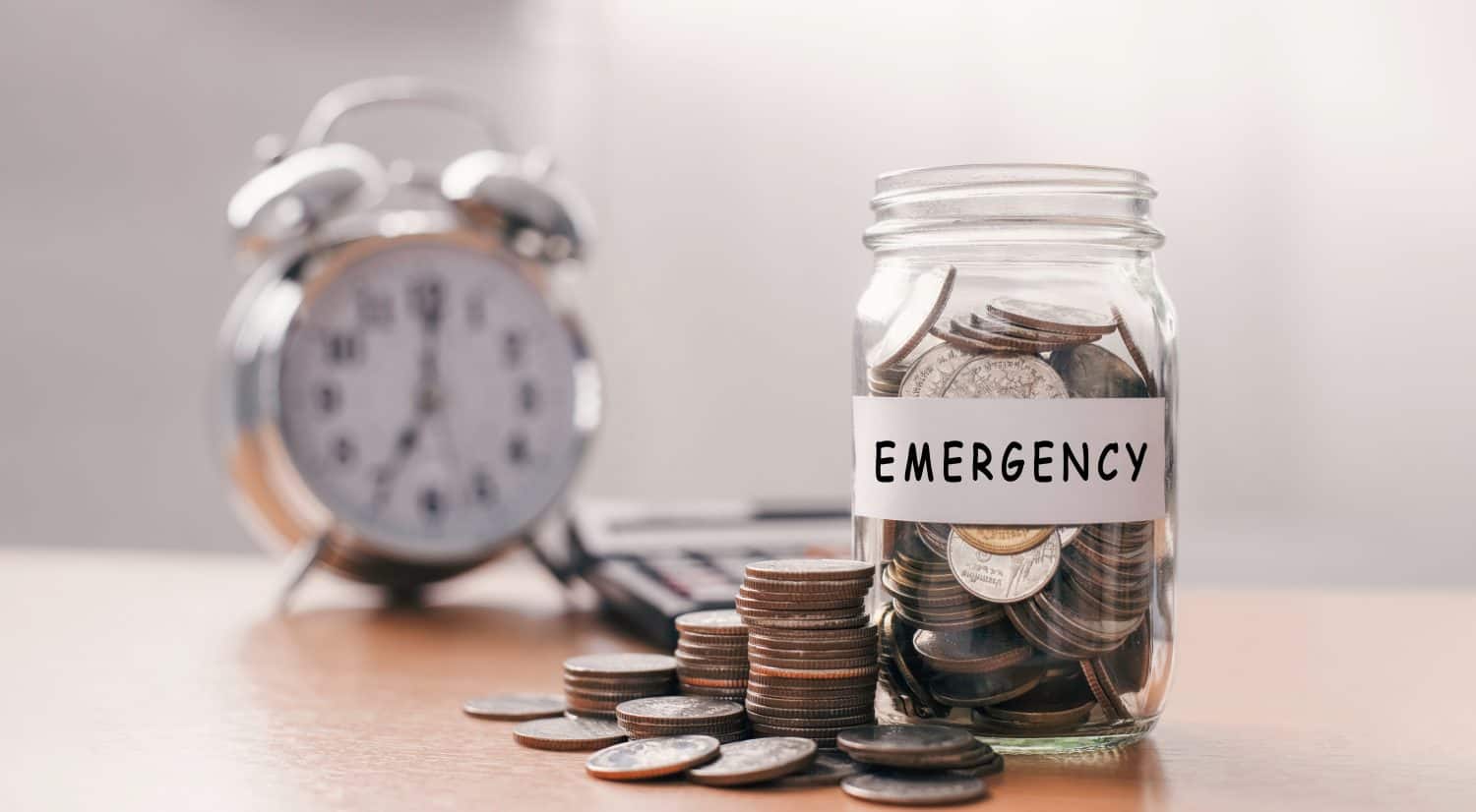 Saving for emergency concept. A lot coins in glass money with piggy bank for saving emergency money.