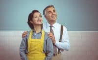 Happy vintage couple at home posing and smiling at camera