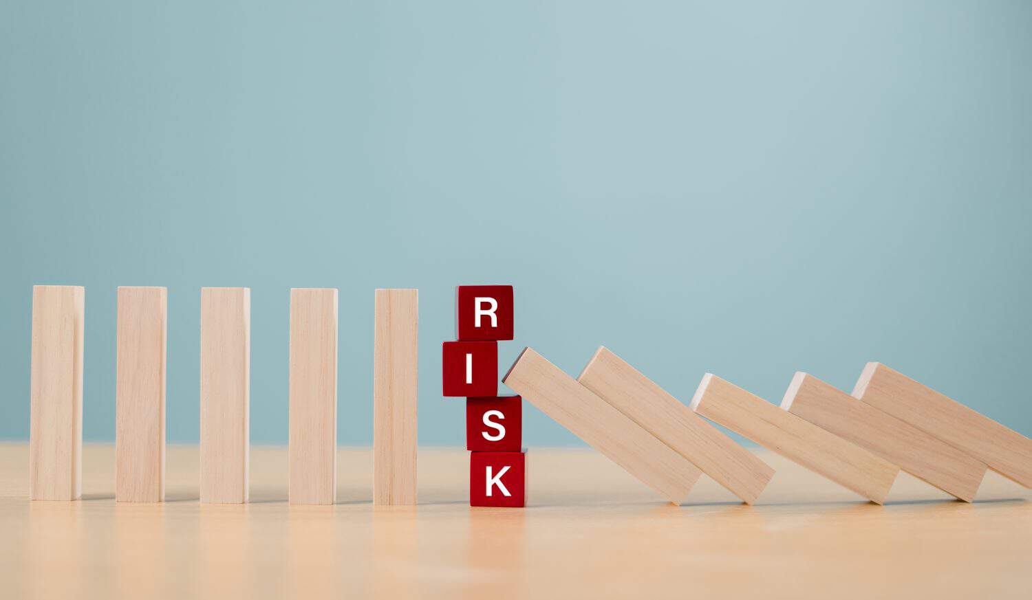 Risk assessment crisis concept. Financial analysis solution, real estate business management. Plan to stop economic risk. Risk word on wooden block, domino crisis reduce effect. Insurance security