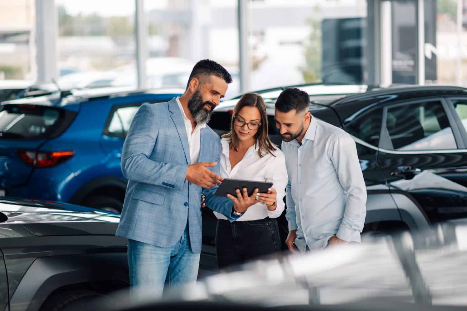 Dynamic interaction showcasing a car dealership's effective communication and sales skills in promoting vehicle features to potential clients in a bright and inviting showroom.