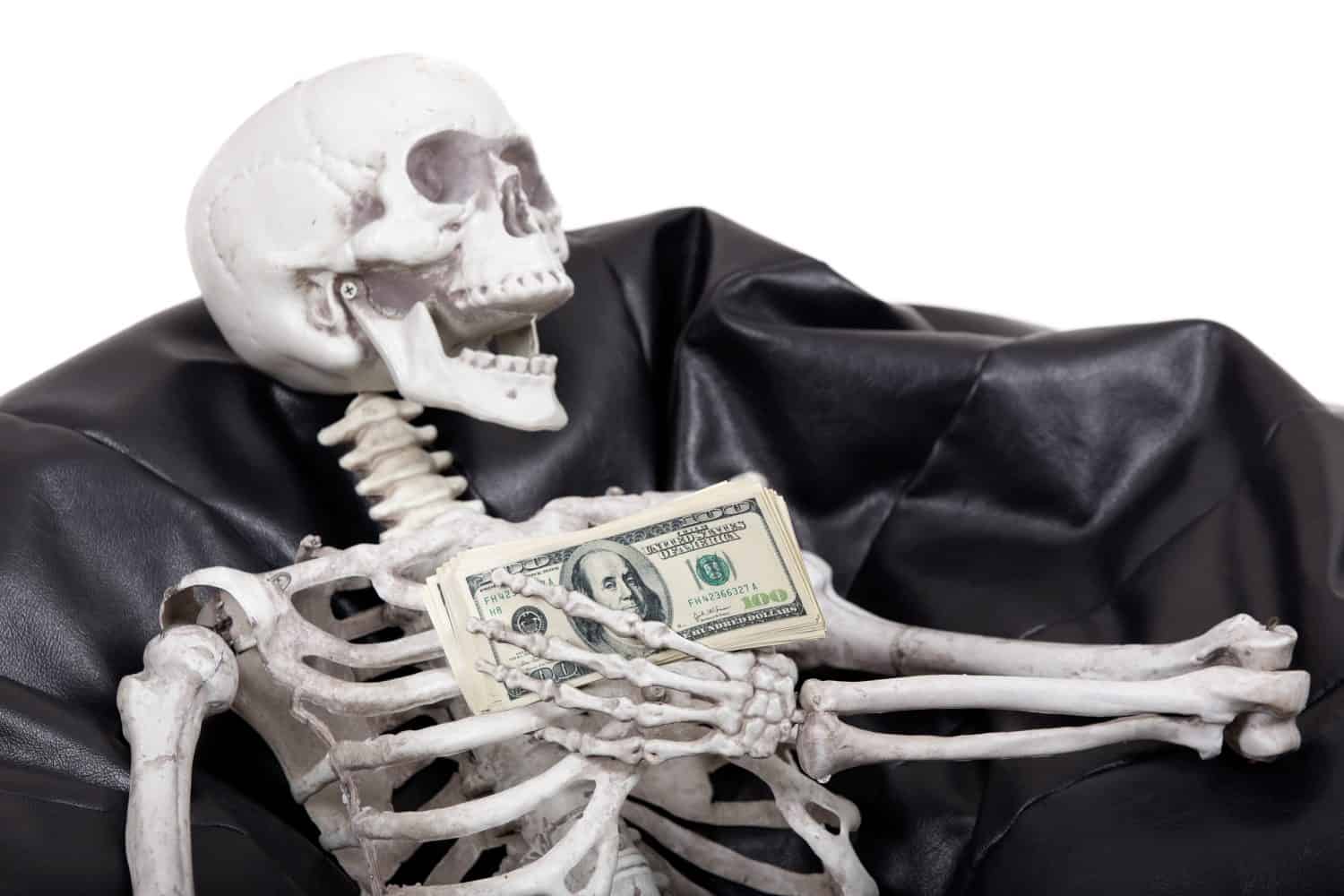 Skeleton holds money.