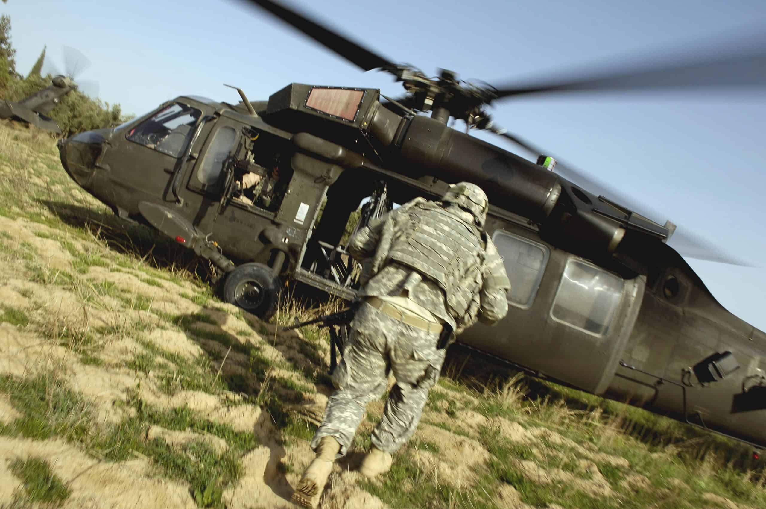 Soldiers prepare to board a UH-60 Black Hawk helicopter.