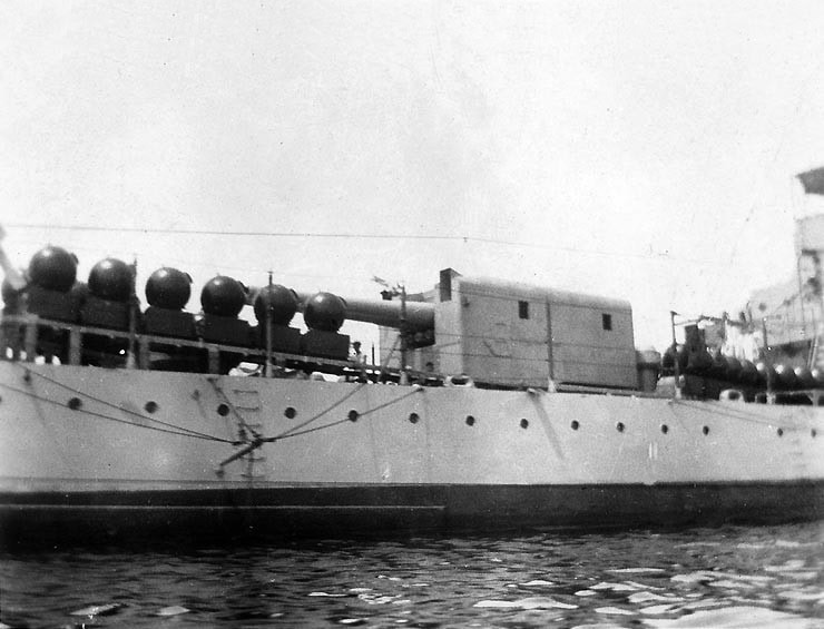  Mines on a U.S. Navy Omaha-class light cruiser, seen from off the ship's starboard quarter, showing mines on their tracks fore and aft of the after six-inch (152 mm) gun mount. The photograph was taken circa 1923-1925, prior to the addition of a deckhouse just forward of the gun mount.