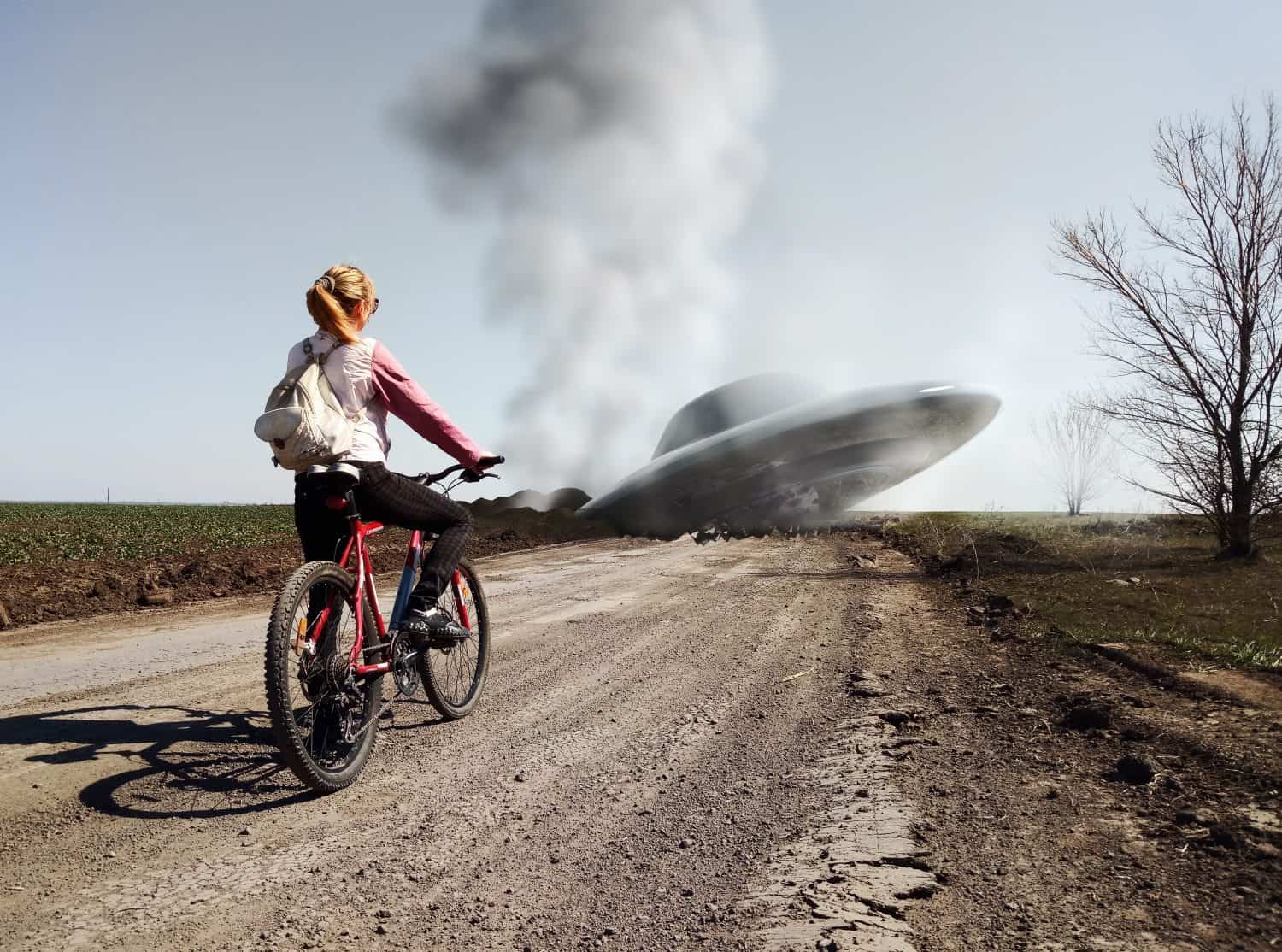 Girl with a bicycle standing near a wrecked UFO. Photo with 3d rendering elements