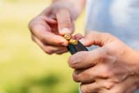 Mid-Adult Man Inserting Bullets Into His Handgun And Preparing For Shooting Practice