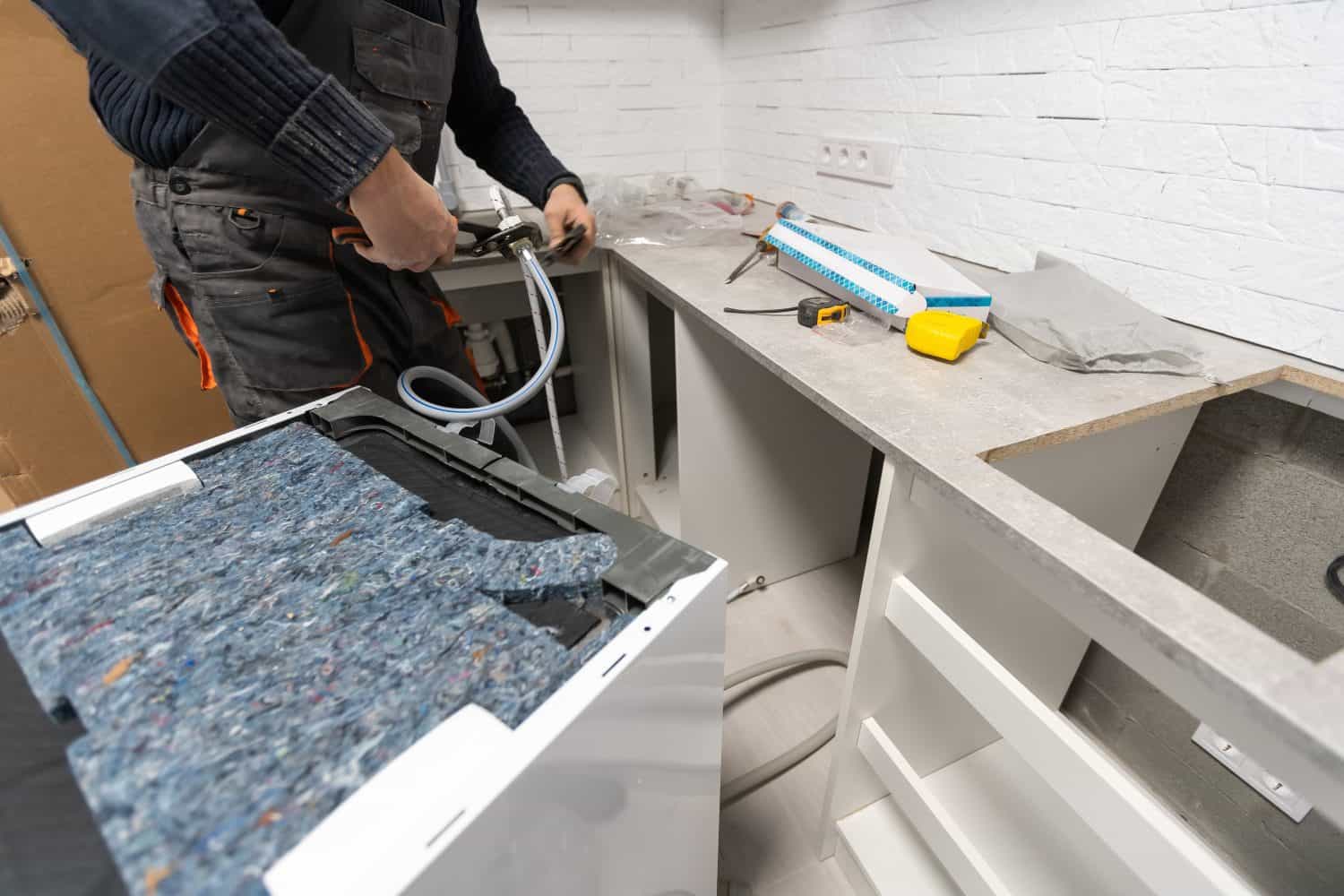 Installation hoses for dishwasher machine domestic connection plumbing pipes in kitchen