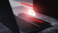 Email spam virus concept. Internet security and cybercrime. Phishing email, fraud, scam and virus warning on laptop.