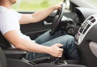 transportation and vehicle concept - man shifting the gear on car manual gearbox