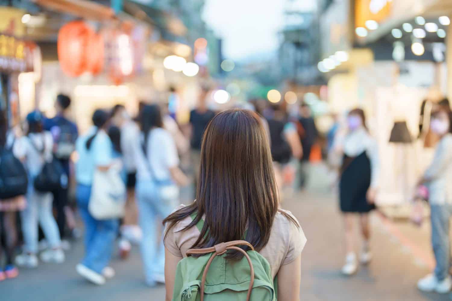 woman traveler visiting in Taiwan, Tourist with bag sightseeing and Shopping in Shilin Night Market, landmark and popular attractions in Taipei city. Asia Travel and Vacation concept