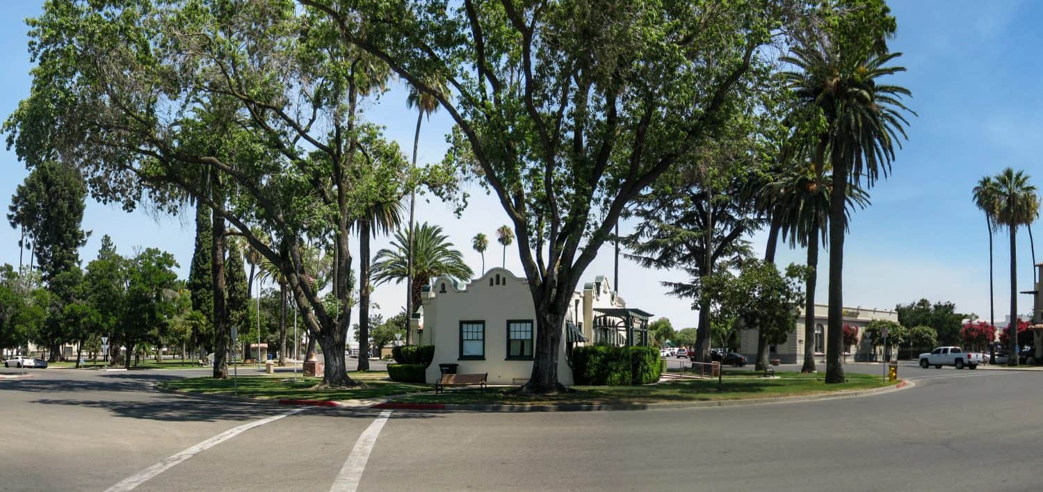Wide view of the historic Patterson California Circle Plaza in the Central Valley shows the Historical Society Museum building from 1910, center.